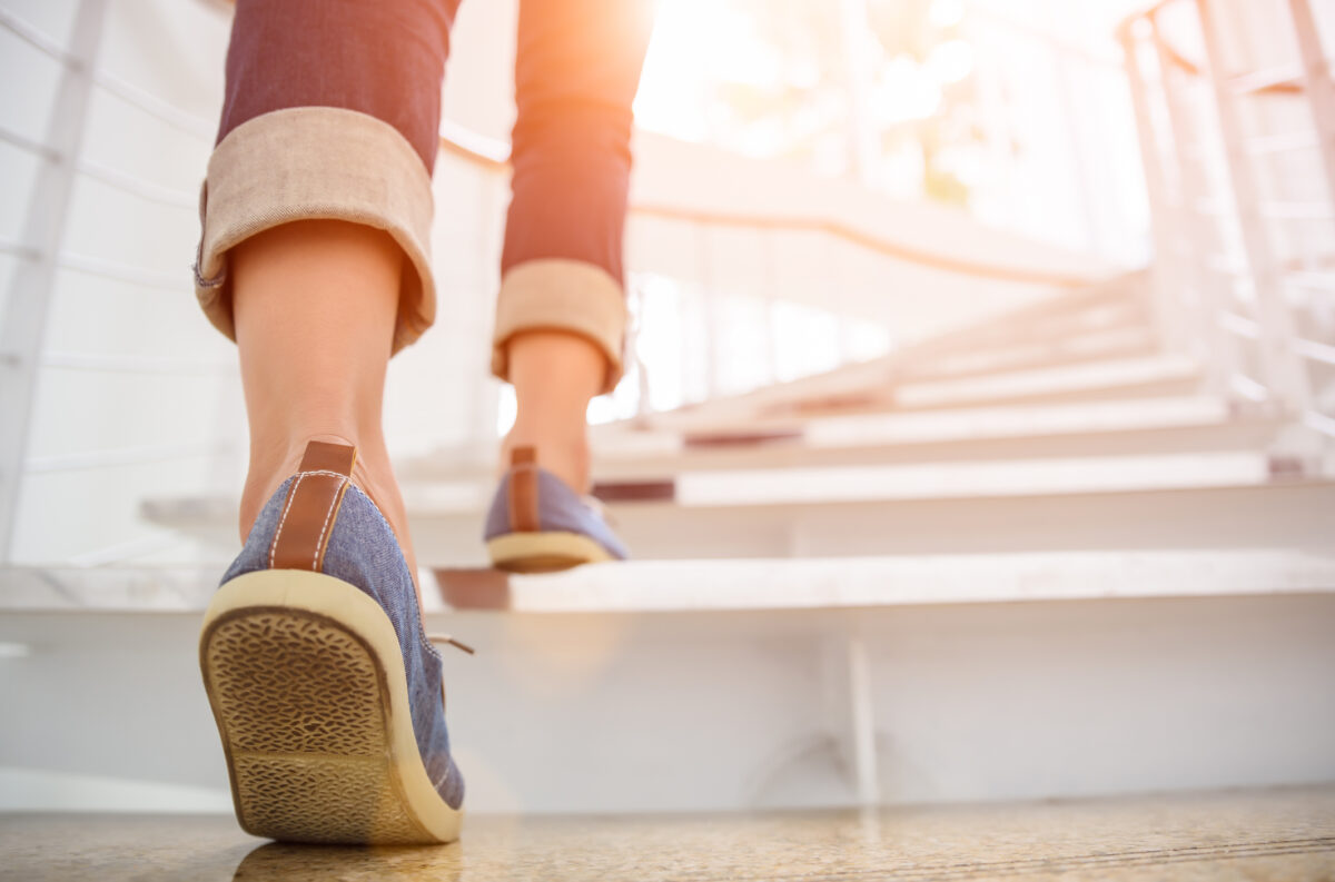image showing a women walking up the stairs