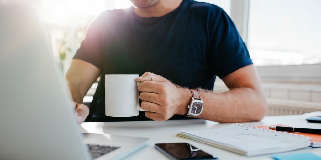 A Man With Glass Of Mug In His Hands Looking At The Drafts